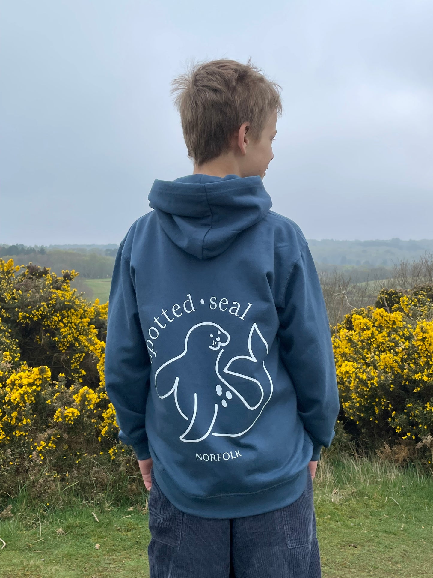 boy wearing children's spotted-seal hoodie in RAF Blue BACK