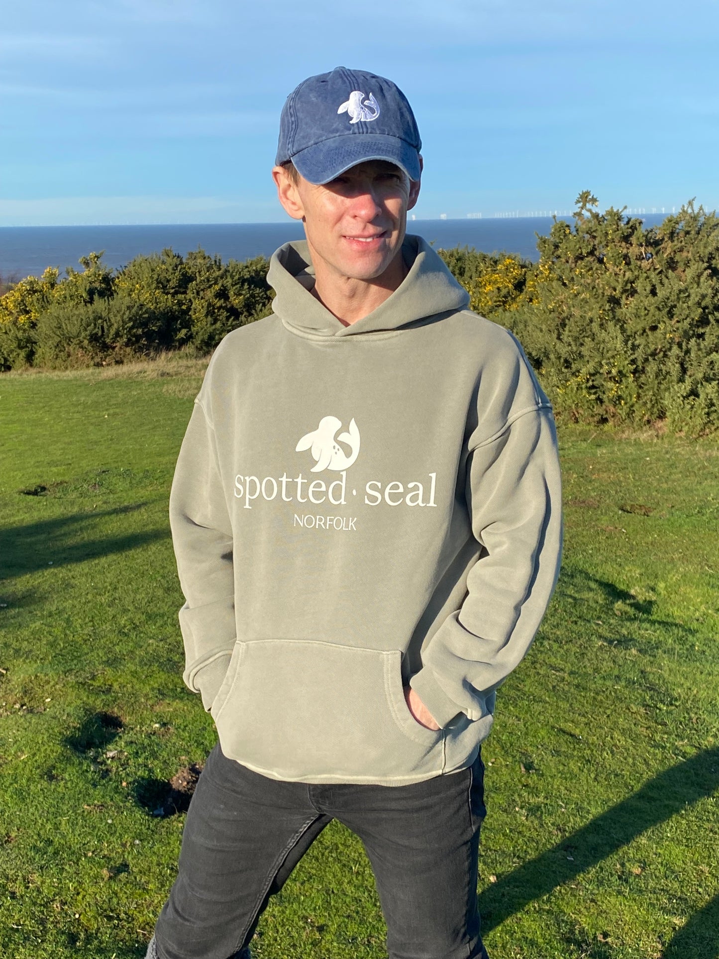 Norfolk coast model in spotted-seal unisex classic hoodie in Morston mist