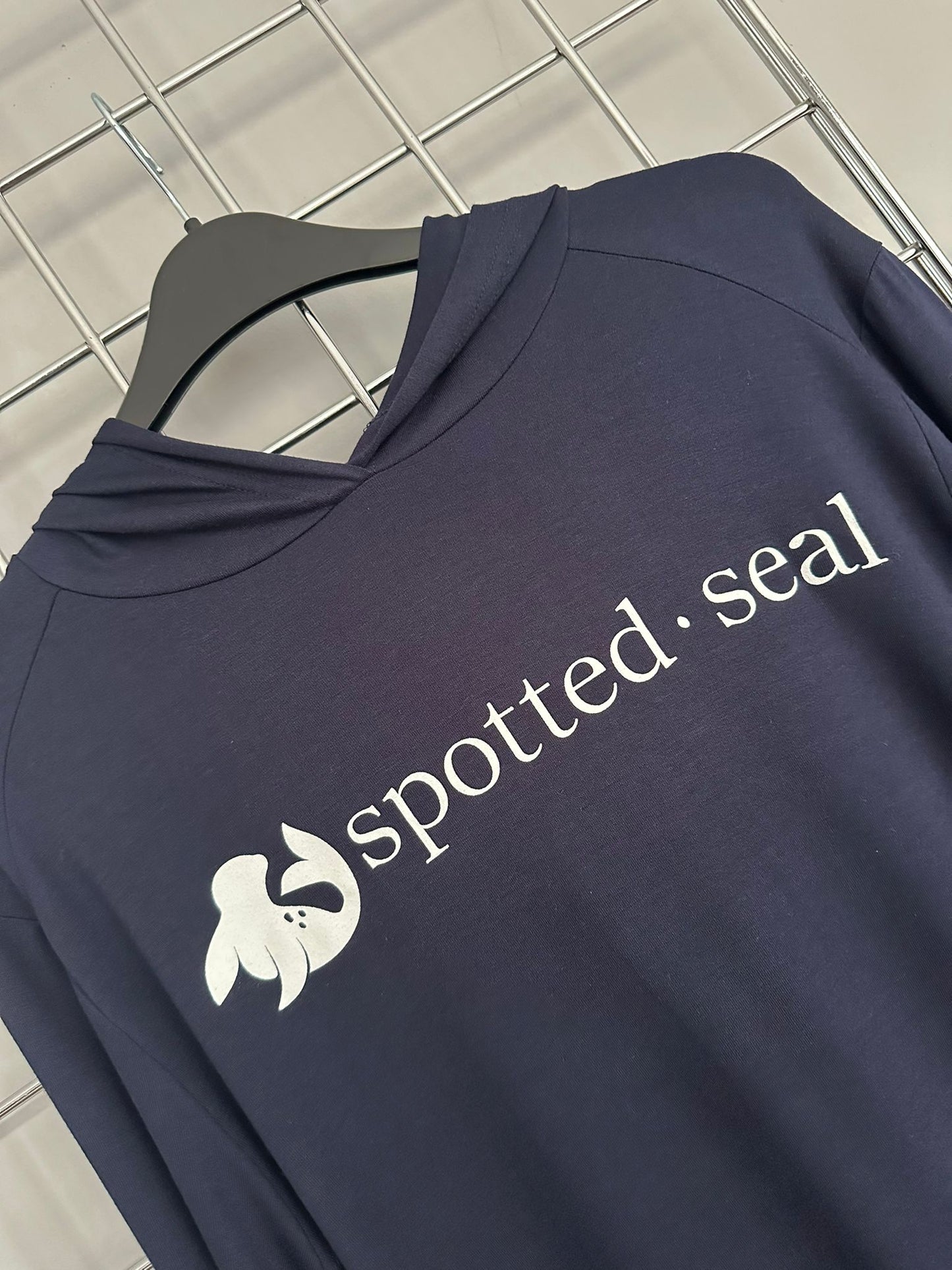 front of spotted-seal long sleeve hooded t-shirt shoodie on hanger.