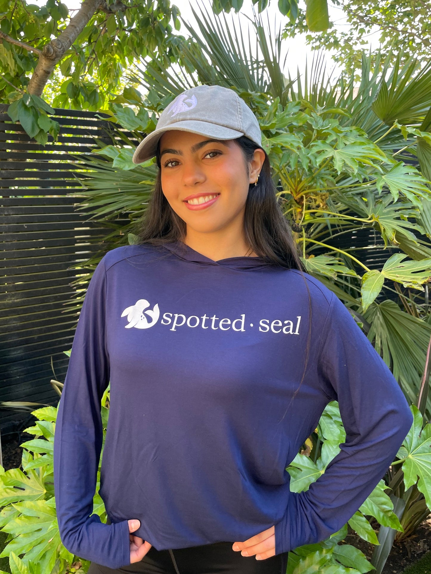 girl in long sleeve hooded t-shirt and spotted-seal cap