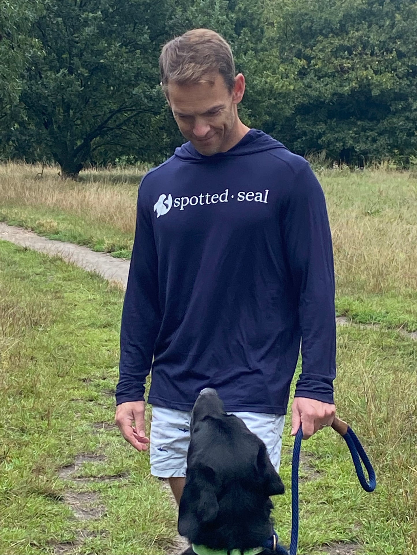 man wearing navy spotted-seal unisex hooded long-sleeve t-shirt 'shoodie' Made in UK