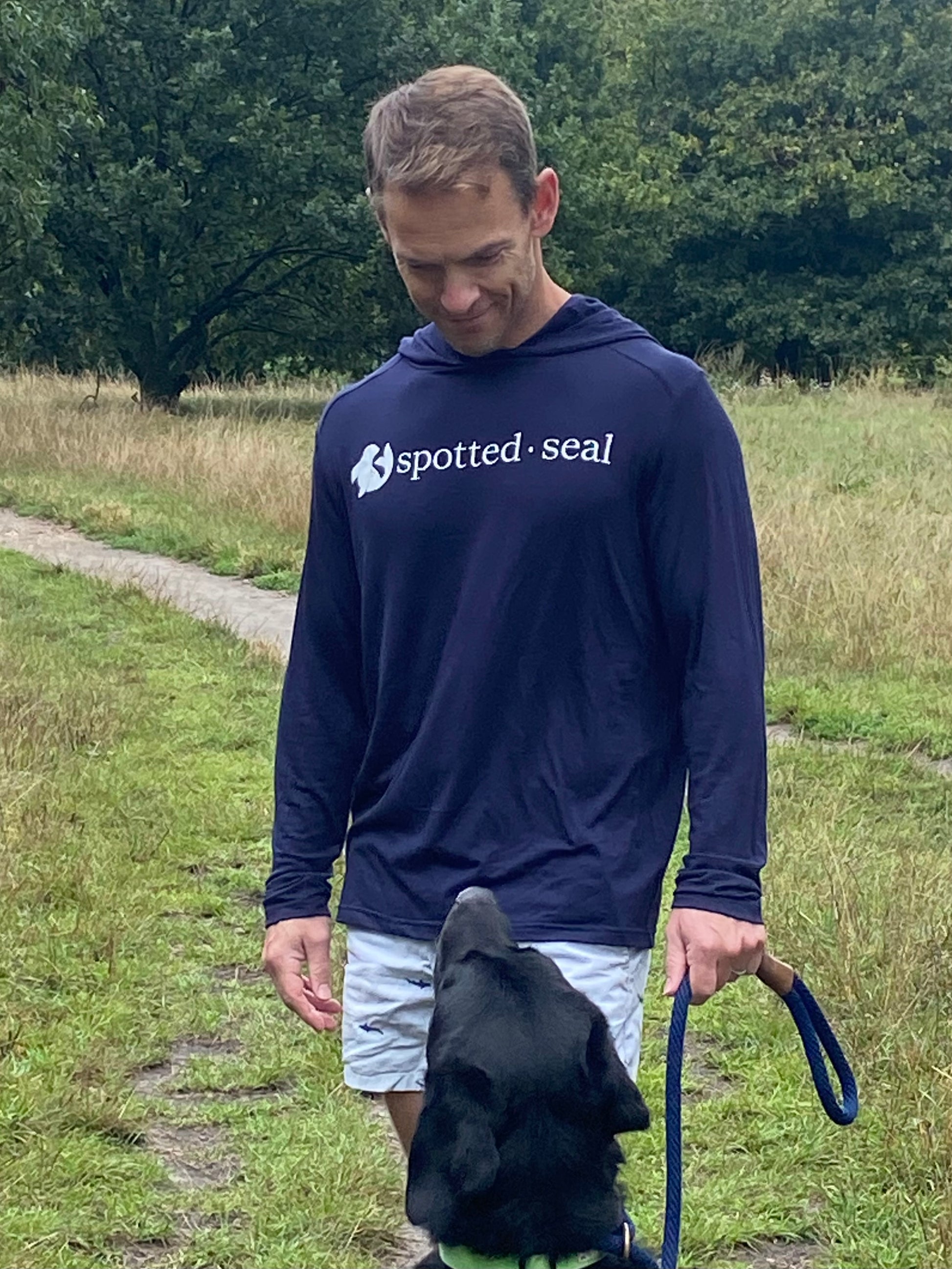 man wearing navy spotted-seal unisex hooded long-sleeve t-shirt 'shoodie' Made in UK