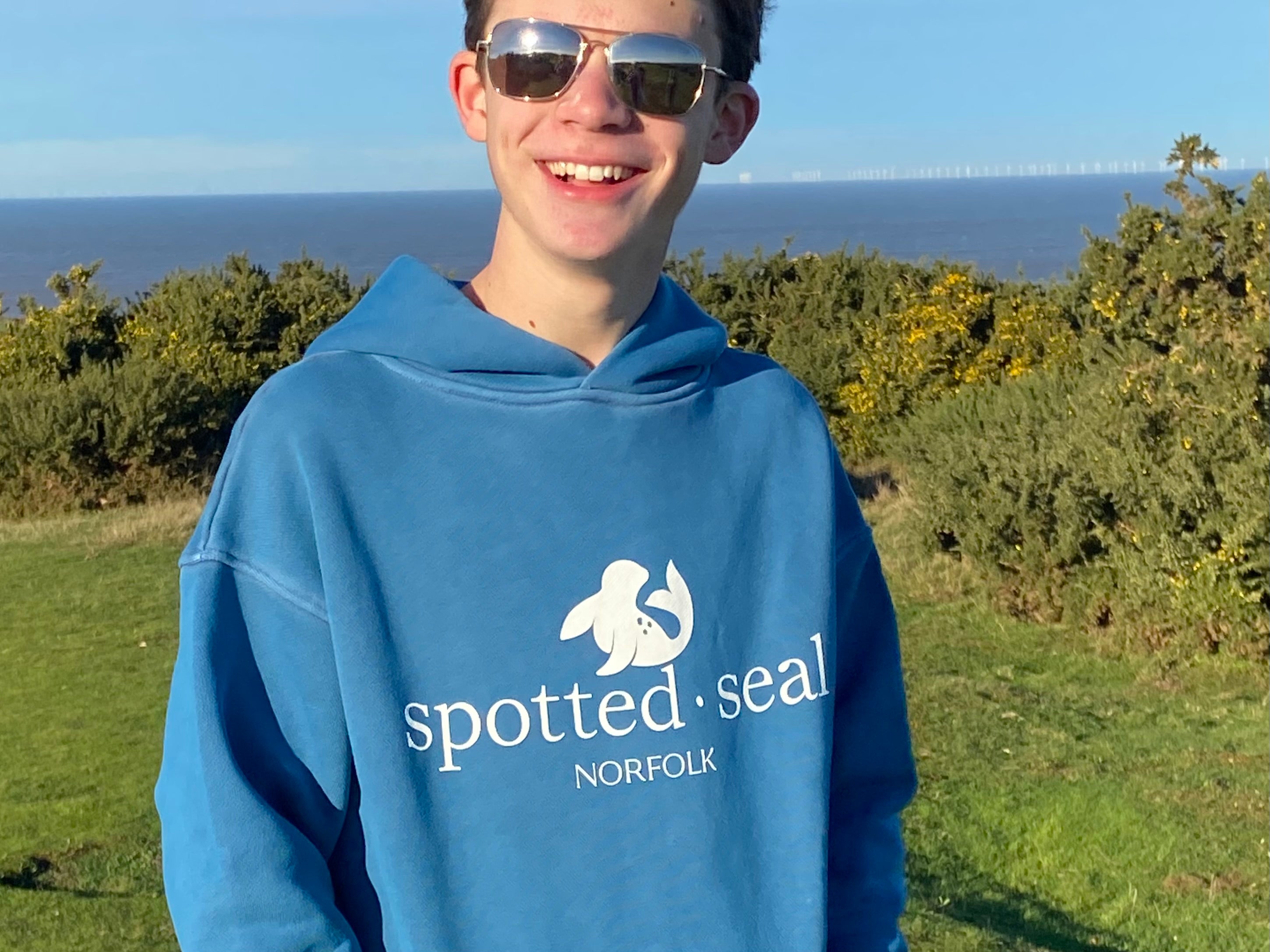 young man wearing royal blue spotted-seal hoodie